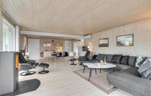a living room with a couch and a table at 3 Bedroom Amazing Home In Hurup Thy in Sindrup