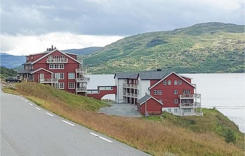 a group of houses on a hill next to a road at Awesome Apartment In Tyinkrysset in Tyinkrysset