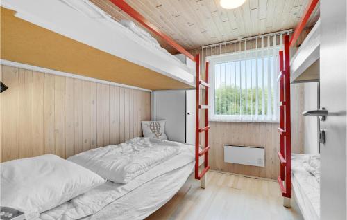 a bedroom with two bunk beds and a window at 3 Bedroom Amazing Home In Hurup Thy in Sindrup