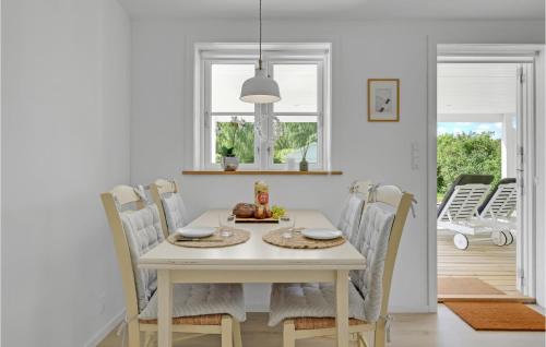 a white dining room with a white table and chairs at 2 Bedroom Beautiful Home In Jægerspris in Jægerspris