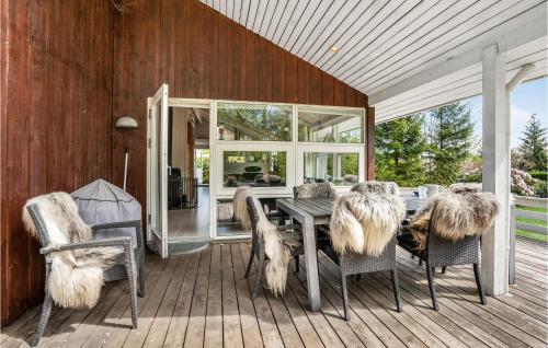 a patio with a table and chairs on a deck at Three-Bedroom Holiday Home In Middelfart in Middelfart