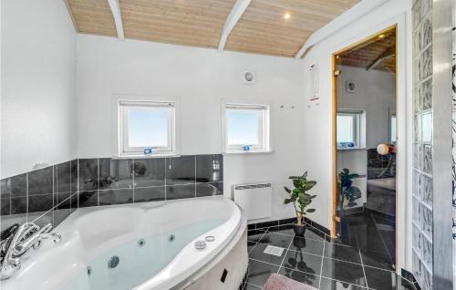 a bath tub in a bathroom with white walls at Three-Bedroom Holiday Home In Middelfart in Middelfart
