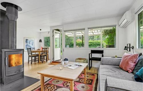 a living room with a couch and a fireplace at Beautiful Home In Egå With Wifi in Egå