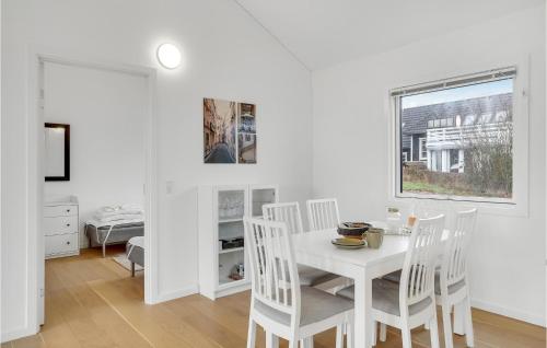 a white dining room with a white table and chairs at Nice Home In Vordingborg With Wifi in Vordingborg