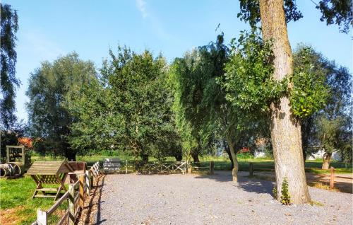 a park with a picnic table and a tree at Amazing Home In Knesselare With Sauna in Knesselare
