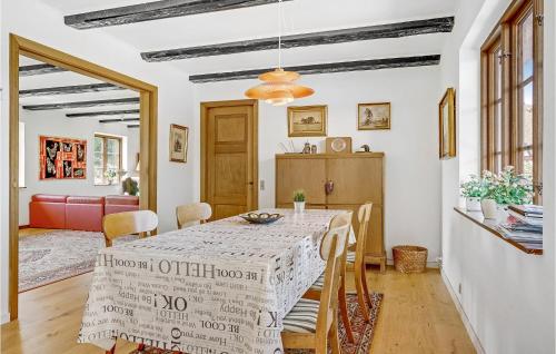 a dining room with a table with a white table cloth at Bredelykke in Gelsted