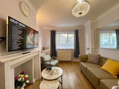 a living room with a couch and a fireplace at Semi Detached House in Aldershot in Aldershot