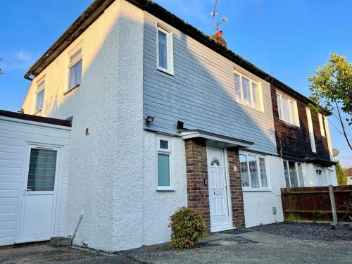 a white brick house with a white garage at Semi Detached House in Aldershot in Aldershot