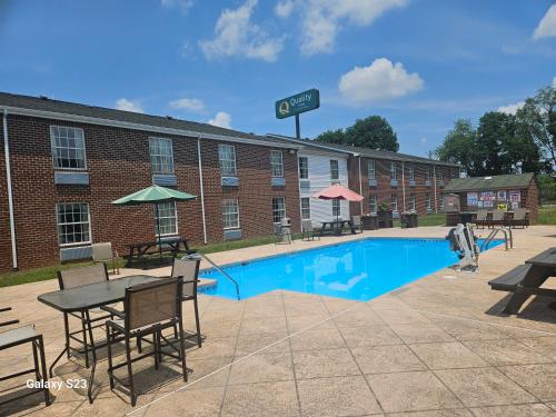 a hotel with a swimming pool in front of a building at Quality Inn Dublin I-81 in Dublin
