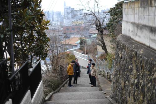 a group of people walking down some stairs at 1166 Backpackers in Nagano