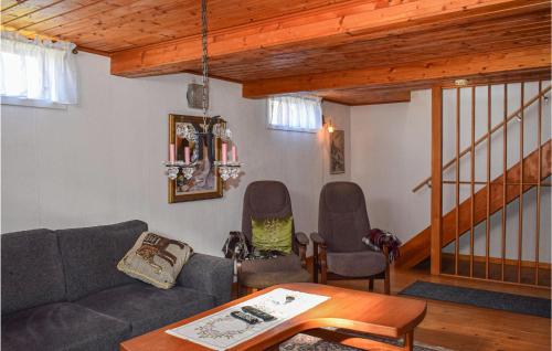 a living room with a couch and two chairs at Gorgeous Home In Burseryd With Kitchen in Sjötofta