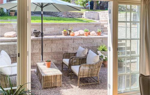 a patio with chairs and a table and an umbrella at 1 Bedroom Lovely Home In Mönsterås in Mönsterås