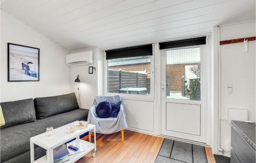 a living room with a couch and a table at Holiday Home Bl in Blåvand