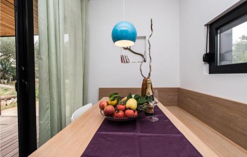 a bowl of fruit on a table in a room at Amazing Home In Dragove in Dragove