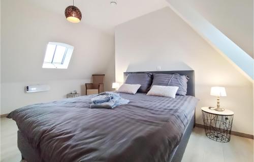 a bedroom with a large bed in a white room at Lovely Home In Knesselare With Wifi in Knesselare