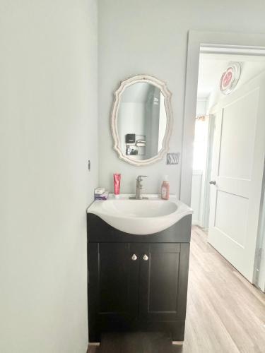 a bathroom with a sink and a mirror at Route 66 Pop Stop-Minutes to Main St in Bandera
