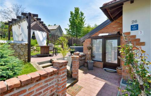 a brick house with a garden and a patio at Lovely Home In Beretinec With Wifi in Beretinec