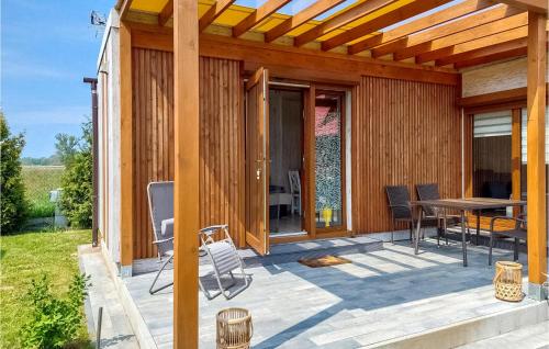 a patio with a table and chairs on a house at Nice Home In Kladno With Wifi in Pleśna