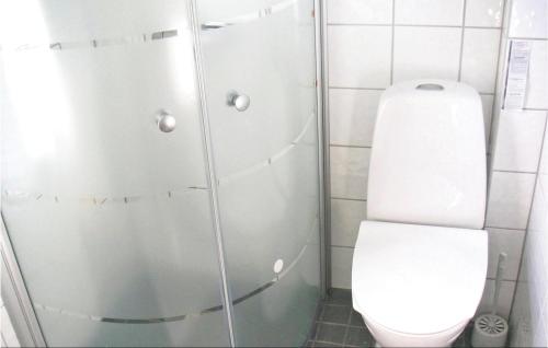 a white bathroom with a toilet and a shower at Holiday Home Nöbblegatan Lenhovda in Lenhovda