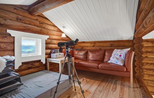a living room with a couch and a camera at 2 Bedroom Cozy Home In Mariager in Mariager