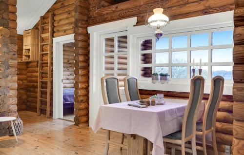 a dining room with a table and chairs and a window at 2 Bedroom Cozy Home In Mariager in Mariager