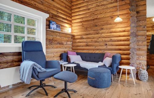 a living room with two chairs and a couch at 2 Bedroom Cozy Home In Mariager in Mariager