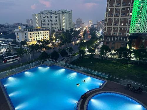 a swimming pool in a city at night at Serviced Green Pearl Apartment in Bac Ninh city in Hòa Ðình