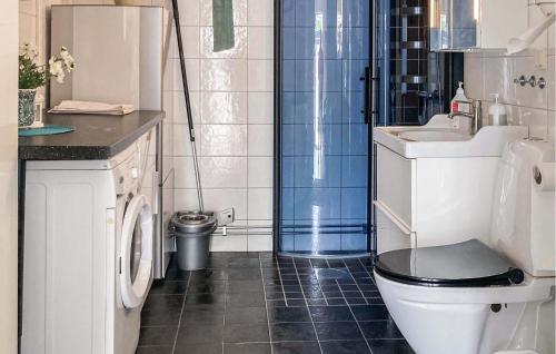 a bathroom with a toilet and a sink and a shower at Cozy Home In Borgholm With Wifi in Borgholm