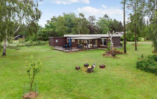 a small house in the middle of a yard at Amazing Home In Stege With Kitchen in Stege