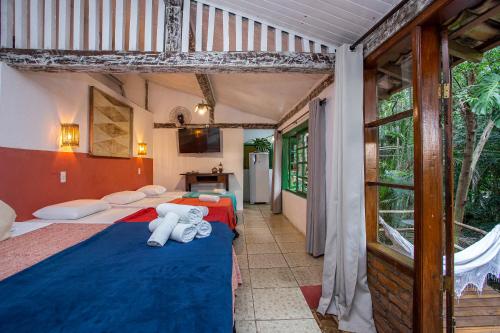 a bedroom with two beds with teddy bears on them at Pousada Encanto das Águas in Ilhabela