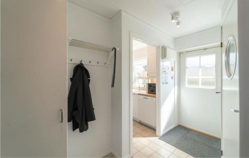 a hallway with a sliding glass door and a kitchen at 1 Bedroom Amazing Home In Köpingsvik in Köpingsvik