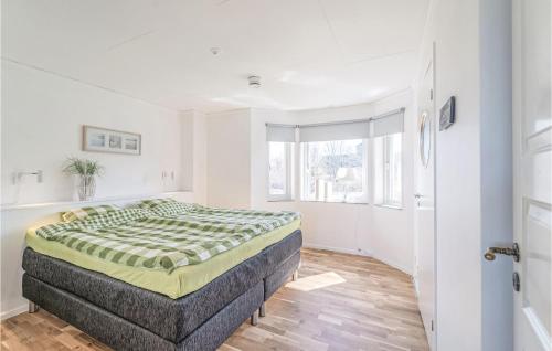 a bedroom with a bed in a white room at 1 Bedroom Amazing Home In Köpingsvik in Köpingsvik