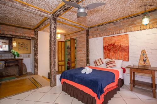 a bedroom with a bed in a brick wall at Pousada Encanto das Águas in Ilhabela