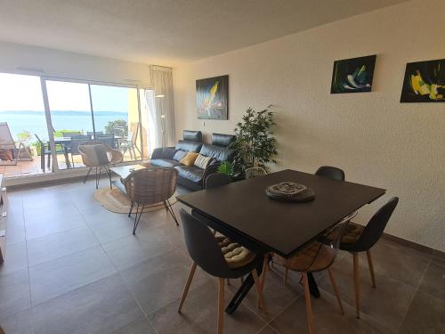 un salon avec une table et un canapé dans l'établissement Appartement 3/4 pièces avec piscine, clim, wifi et parking à Sainte-Maxime - FR-1-780-23, à Sainte-Maxime