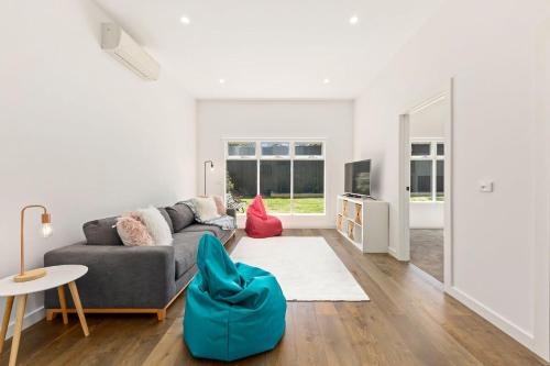 a living room with a couch and a table at North Haven family beach retreat in Mount Martha
