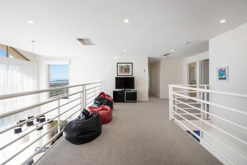 a hallway with two bags on the floor of a building at Vue de la Mer Luxe Retreat - Tennis, Pool, Views in Mount Martha