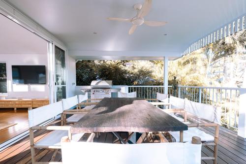 a dining room with a table and chairs at Tallows House on Paterson in Byron Bay