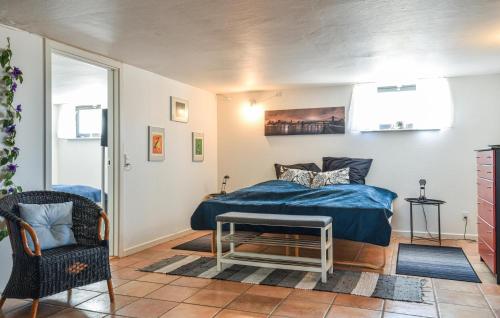 a bedroom with a bed and a chair and a table at Krukken in Vang