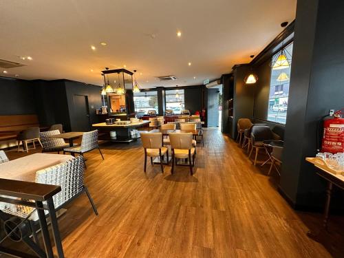 a restaurant with tables and chairs in a room at Merchant Hotel in George Town