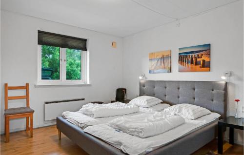 a bedroom with a large bed with white pillows at One-Bedroom Holiday Home In Ribe in Ribe