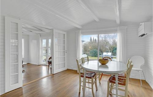 a white dining room with a white table and chairs at Amazing Home In Rødvig Stevns With Wifi in Rødvig