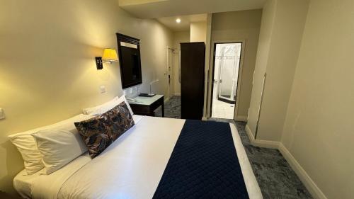 a bedroom with a large white bed in a room at Trinity Hotel in Wellington