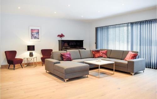 a living room with a couch and a table at Cozy Home In Treungen With Wifi in Treungen