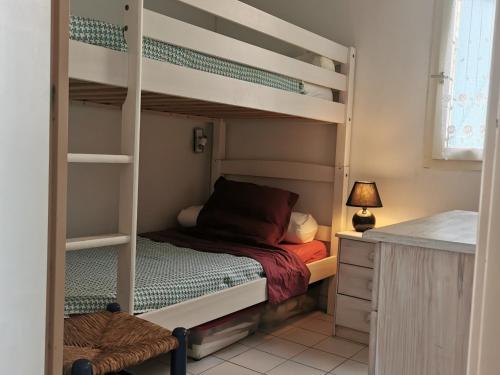 une chambre avec deux lits superposés et un bureau dans l'établissement Villa Climatisée Bord de l'Eau - 4/5 pers - Proche Plage avec Parking Privé - FR-1-796-30, à Gruissan