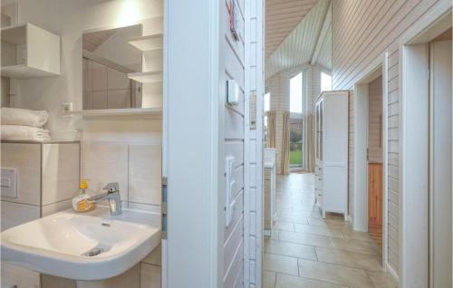 a bathroom with a sink and a hallway at Nice Home In Krems Iiwarderbrück in Göls