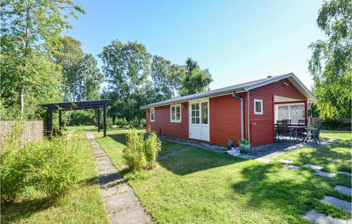 a red tiny house in a yard at Holiday Home Østerskovvej Grenaa Xii in Grenå