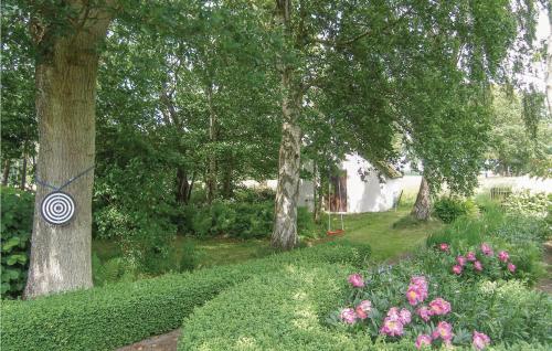 a garden with pink flowers and trees and trees at Gorgeous Home In Blentarp With Wifi in Blentarp