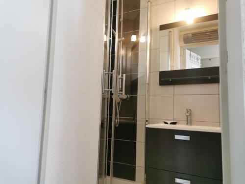 une salle de bain avec douche et lavabo dans l'établissement Direct Plage, Piscine et Parking - Confort Moderne pour 4 Pers - FR-1-796-37, à Gruissan