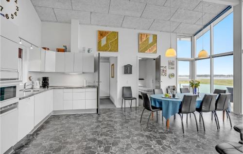 a kitchen and dining room with a table and chairs at Three-Bedroom Holiday Home In Skals in Skals