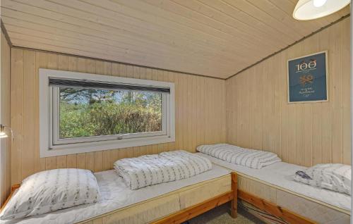 two beds in a room with a window at Beautiful Home In Rudkøbing With Wifi in Spodsbjerg
